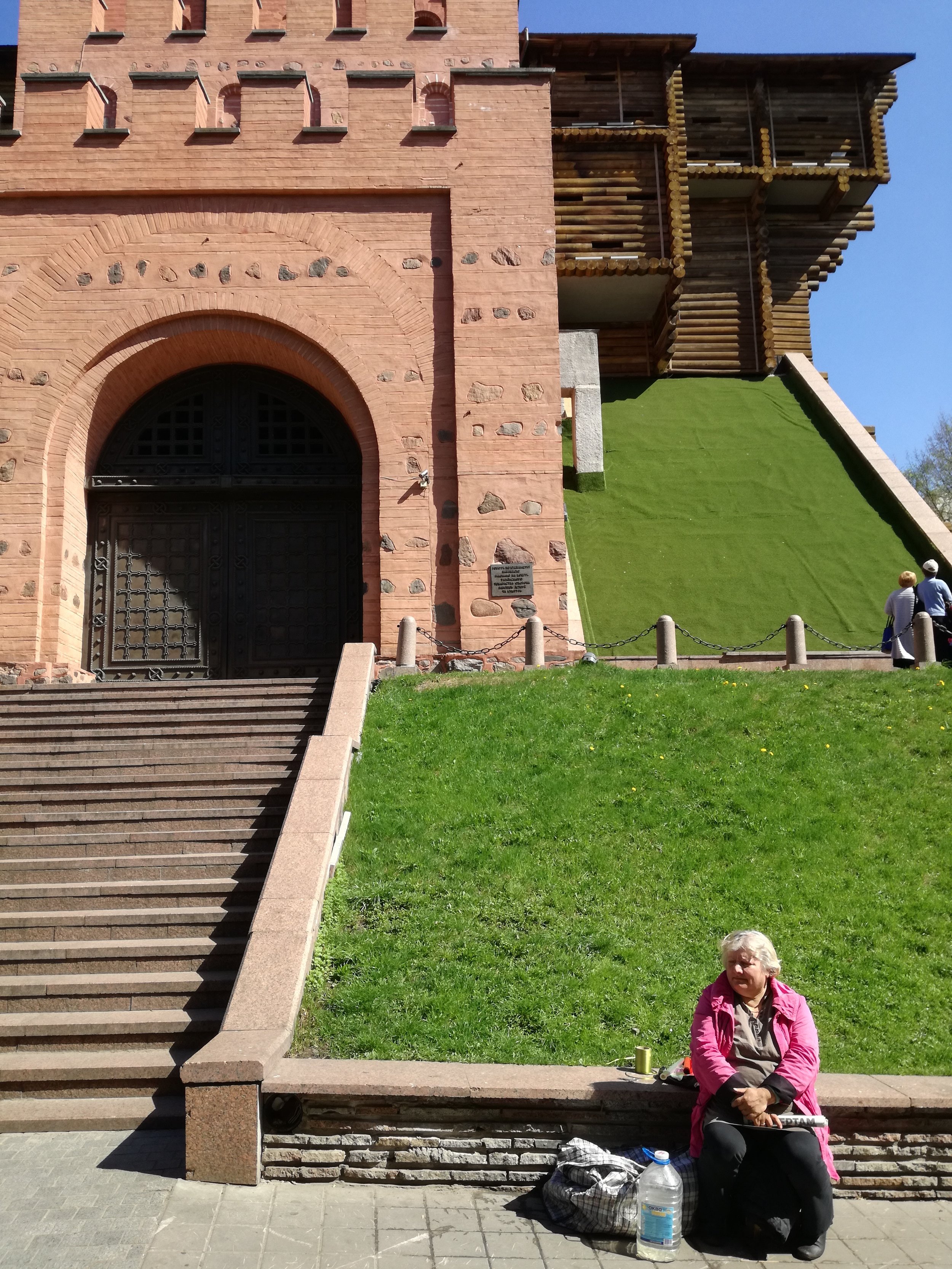 Old granny in front of Golden Gate in Kyiv, Ukraine