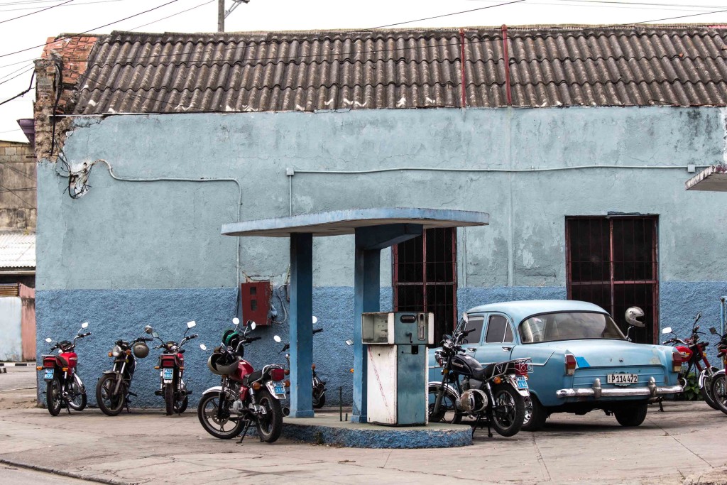 Motorcycles and a car on the gas station