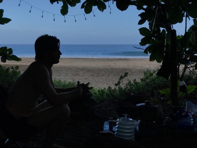 A man on the sandy beach in Kauai