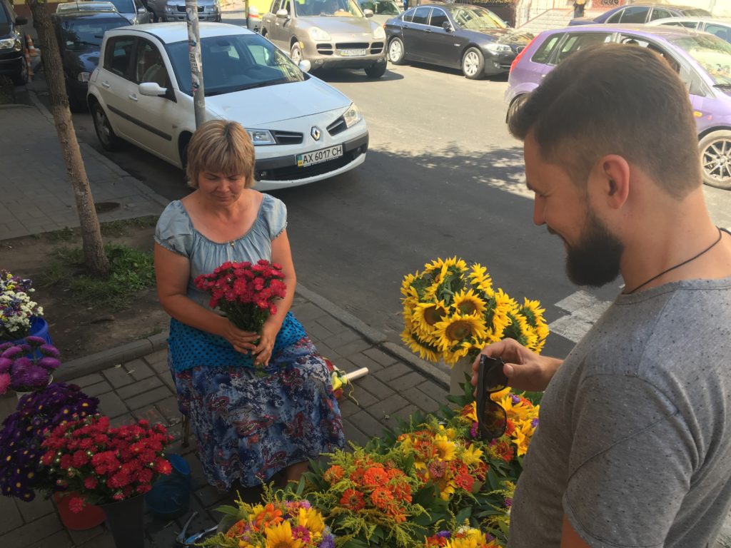 A man buying flowers on the street in Kyiv, Ukraine