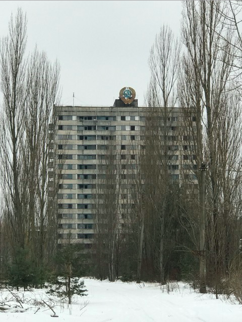 Ghost city Pripyat. Nature taking over. Hamer and sickle on top of a "block."